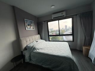 Spacious, well-lit bedroom with city view
