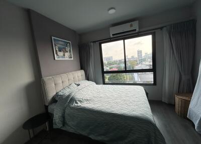 Spacious, well-lit bedroom with city view
