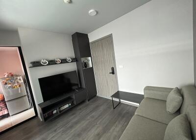 modern living room with L-shaped sofa and mounted television