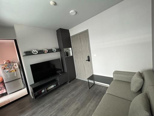 modern living room with L-shaped sofa and mounted television