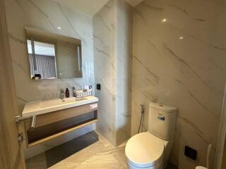 Modern bathroom interior with elegant marble tiles and wooden vanity