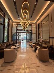 Luxurious hotel lobby with modern chandelier and elegant furnishings