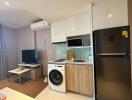 Modern compact kitchen with integrated appliances and living space