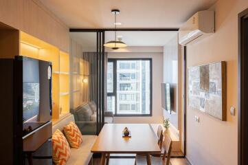 Modern and cozy living room with balcony access and ample natural light