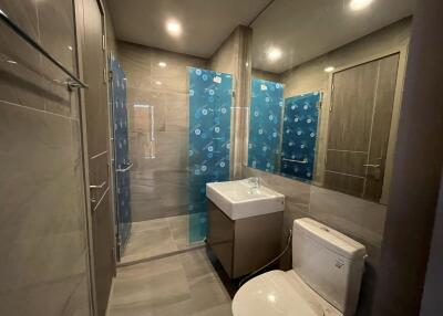 Spacious modern bathroom with glass shower and stylish fixtures