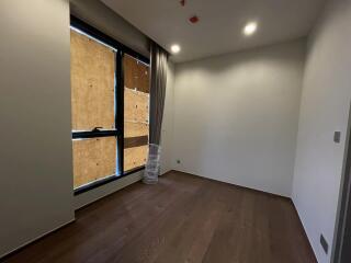 Unfurnished bedroom with wooden flooring and large window