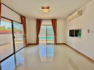 Spacious and brightly lit living room with large windows and modern amenities