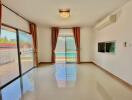 Spacious and brightly lit living room with large windows and modern amenities
