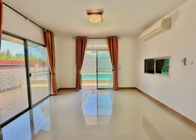 Spacious and brightly lit living room with large windows and modern amenities