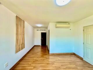 Spacious hallway with wooden flooring and modern lighting