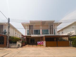 Spacious two-story house for sale with a large gated entrance and balcony