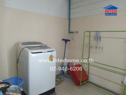 Utility area with washing machine and cleaning tools