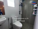 Modern bathroom with gray tiles and essential fixtures