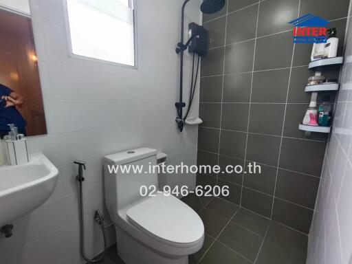 Modern bathroom with gray tiles and essential fixtures