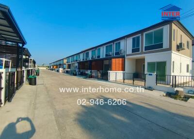 Row of townhouses in a residential neighborhood under clear blue sky