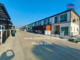 Row of townhouses in a residential neighborhood under clear blue sky