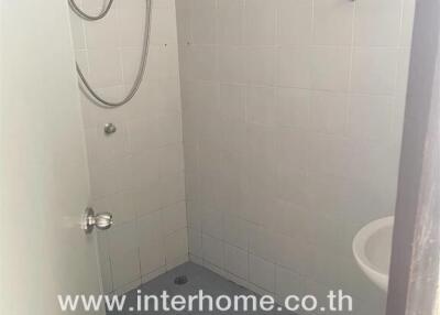 Compact bathroom with shower and white tiles