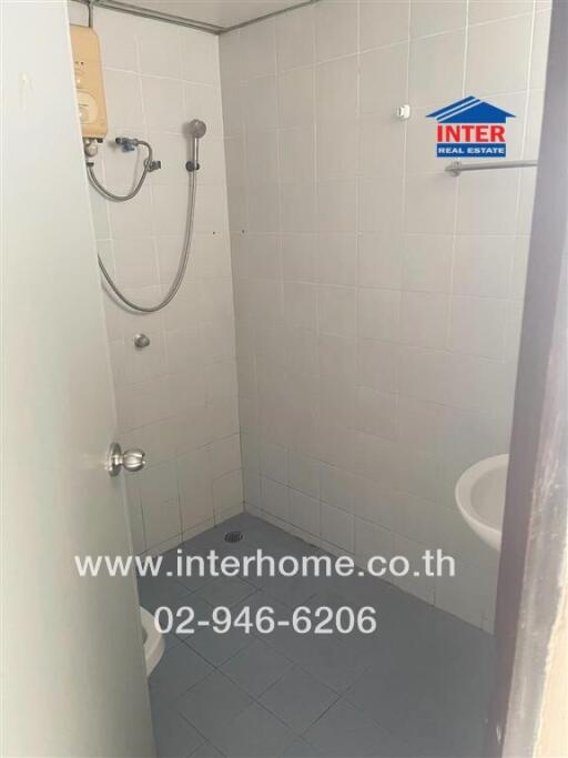 Compact bathroom with shower and white tiles