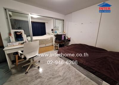 Spacious bedroom with large bed and mirror