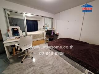 Spacious bedroom with large bed and mirror