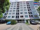 Exterior view of a modern residential apartment building with parked cars