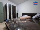 Modern furnished bedroom with dark tones and ample storage