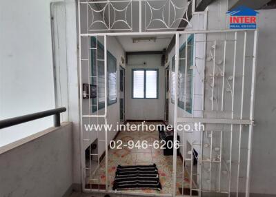 Secure entrance of an apartment showing metal grills and tiled floor