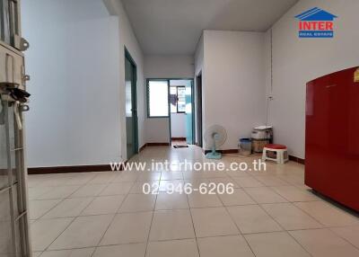 Spacious unfurnished living area with white walls and tiled floors