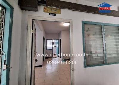 Entrance view of an apartment building with visible interior hallway