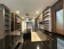 Modern kitchen with glossy black countertops and wooden accents