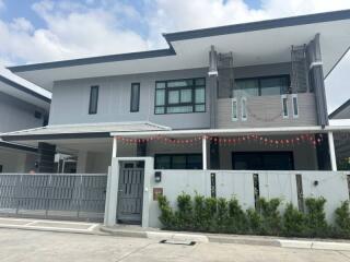 Modern two-story house with gray exteriors and decorative features