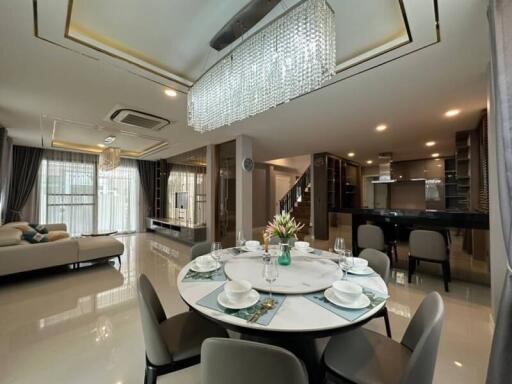Elegant and spacious living area with dining setup and integrated kitchen