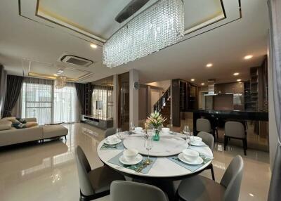 Elegant and spacious living area with dining setup and integrated kitchen