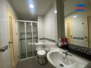 Modern bathroom interior with glass shower enclosure and sleek fixtures