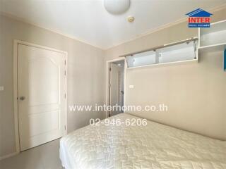 Spacious and well-lit bedroom with large bed and mirrored wardrobe
