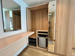 Modern bedroom with wooden built-in wardrobe and vanity