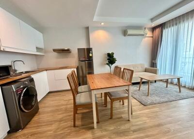 Modern kitchen and living space with dining area