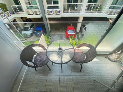 Spacious balcony with outdoor seating and urban view