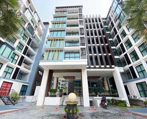 Modern residential apartment building facade with lush greenery