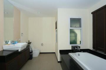 Modern bathroom with sleek design featuring large mirror and window