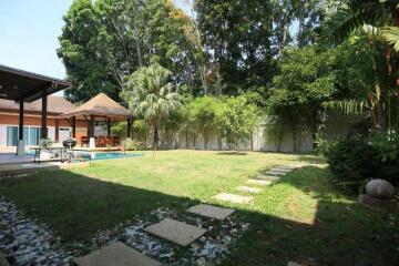 Lush garden with swimming pool and pavilion