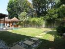 Lush garden with swimming pool and pavilion