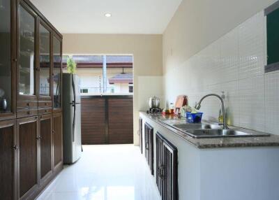 Spacious and well-equipped kitchen with modern amenities and ample natural light