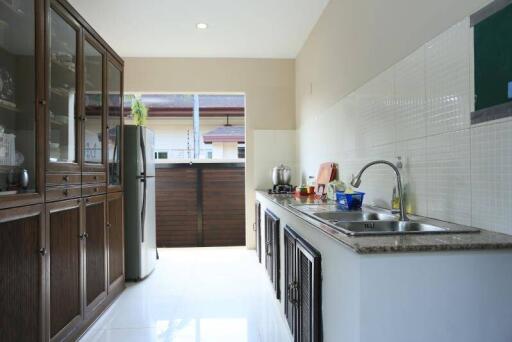 Spacious and well-equipped kitchen with modern amenities and ample natural light