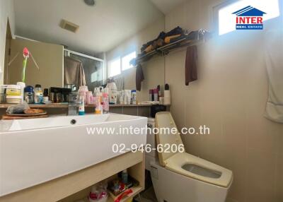 Compact bathroom with storage space and modern amenities