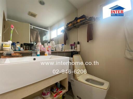 Compact bathroom with storage space and modern amenities