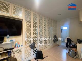 Spacious living room with decorative partition and modern amenities