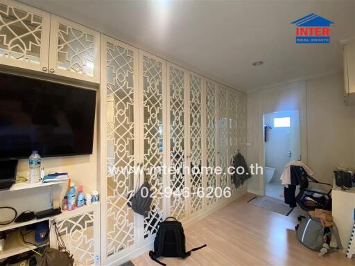 Spacious living room with decorative partition and modern amenities
