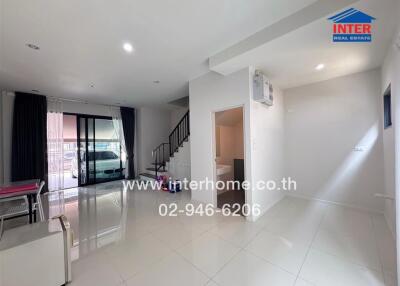 Spacious and modern living room with natural lighting and direct access to the garage