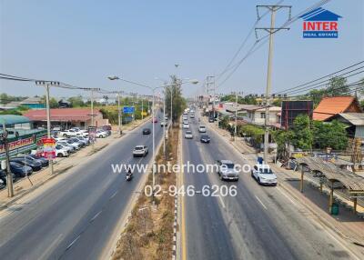 Busy suburban street with traffic and commercial signs